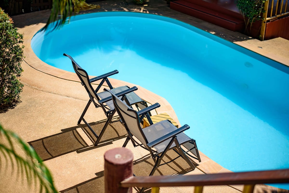 lounge chairs beside pool — Outdoor area of Villa Siam Lanna, private pool villa in Koh Lanta